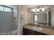 Modern bathroom featuring a marble-tiled standing shower and a sink with brown cabinets and granite counters at 3600 N Hayden Rd # 3002, Scottsdale, AZ 85251