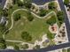 Aerial view of a community park with pathways, playground, and green spaces for residents to enjoy at 3641 E Los Gatos Dr, Phoenix, AZ 85050