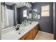 Bathroom with double sink vanity, stylish lighting, and neutral color scheme at 3641 E Los Gatos Dr, Phoenix, AZ 85050