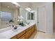 Bright bathroom featuring double sinks, a soaking tub, and natural light at 3641 E Los Gatos Dr, Phoenix, AZ 85050