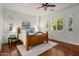 Cozy bedroom with a wood bed frame, wood-look floors, and plantation shutters for natural light at 3641 E Los Gatos Dr, Phoenix, AZ 85050