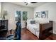 Bedroom with wood floors, bright window, desk and blue gaming chair at 3641 E Los Gatos Dr, Phoenix, AZ 85050