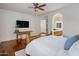 Spacious bedroom with an en-suite bathroom and a mounted TV at 3641 E Los Gatos Dr, Phoenix, AZ 85050