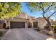 Desert home boasts a three car garage with tile roof and mature landscaping at 3641 E Los Gatos Dr, Phoenix, AZ 85050