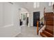 Bright foyer with wood floors, staircase, archway and front door at 3641 E Los Gatos Dr, Phoenix, AZ 85050