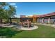 Inviting entrance with lush landscaping and a charming water feature under a sunny, blue sky at 3641 E Los Gatos Dr, Phoenix, AZ 85050