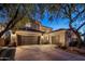 Desert home boasts a three car garage with tile roof and mature landscaping at 3641 E Los Gatos Dr, Phoenix, AZ 85050