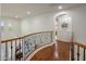 Upstairs hallway with wood floors, decorative railing and archway at 3641 E Los Gatos Dr, Phoenix, AZ 85050