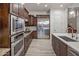 Kitchen showcasing stainless steel appliances, custom cabinets, and light wood-look flooring at 3641 E Los Gatos Dr, Phoenix, AZ 85050