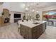 Open concept kitchen features a large island, modern lighting, and fireplace views at 3641 E Los Gatos Dr, Phoenix, AZ 85050