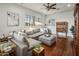 Spacious living room with hardwood floors, sectional sofa, and bright windows at 3641 E Los Gatos Dr, Phoenix, AZ 85050