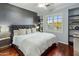 Comfortable main bedroom with dark accent wall, hardwood floors, and bright windows at 3641 E Los Gatos Dr, Phoenix, AZ 85050