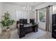 Bright office features a modern chandelier, plantation shutters, and a spacious dark wood desk at 3641 E Los Gatos Dr, Phoenix, AZ 85050