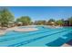 Large community pool with lap lanes and leisure areas, surrounded by lounge seating and shade structures at 3641 E Los Gatos Dr, Phoenix, AZ 85050