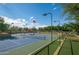 Well-maintained community tennis court with views of the surrounding neighborhood and an American flag at 3641 E Los Gatos Dr, Phoenix, AZ 85050