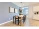 Cozy dining room featuring a modern table setting and stylish wall decor at 36525 W Maddaloni Ave, Maricopa, AZ 85138