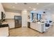 Stylish kitchen featuring white cabinetry, stainless steel appliances, and bar stool seating at 36525 W Maddaloni Ave, Maricopa, AZ 85138