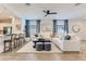 Bright living room featuring recessed lighting, a modern ceiling fan, and stylish blue accents at 36525 W Maddaloni Ave, Maricopa, AZ 85138