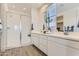 Elegant main bathroom with double vanity, quartz counters, and a glass-enclosed shower at 36525 W Maddaloni Ave, Maricopa, AZ 85138