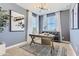 This modern-designed office includes a work desk, large windows, and simple decor to create a productive workspace at 36525 W Maddaloni Ave, Maricopa, AZ 85138