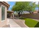Well-maintained backyard featuring an outdoor grill, stone patio, and small patch of green grass at 3711 E Long Lake Rd, Phoenix, AZ 85048