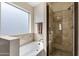 Bathroom with garden tub and enclosed glass shower, along with a large frosted window at 3711 E Long Lake Rd, Phoenix, AZ 85048
