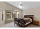 A main bedroom featuring a large window, ceiling fan and neutral carpet at 3711 E Long Lake Rd, Phoenix, AZ 85048