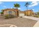 Charming single-story home with desert landscaping, palm trees and a tile roof at 3711 E Long Lake Rd, Phoenix, AZ 85048