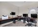 Spacious home office with a large corner desk, multiple monitors, printer and a whiteboard at 3711 E Long Lake Rd, Phoenix, AZ 85048