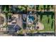 An aerial view showcases a backyard oasis featuring a sparkling pool, lush landscaping, grassy area, trampoline and outdoor dining at 3754 E Flintlock Dr, Queen Creek, AZ 85142
