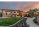 Expansive backyard featuring a well-manicured lawn, mature landscaping, and a covered patio, perfect for outdoor living at 3754 E Flintlock Dr, Queen Creek, AZ 85142