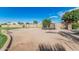 Spacious backyard area features a sandpit with a trampoline, disc golf baskets and surrounding block wall at 3754 E Flintlock Dr, Queen Creek, AZ 85142
