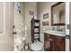 Compact bathroom with a decorative mirror, rustic wooden shelves, and patterned towels, creating a warm and inviting space at 3754 E Flintlock Dr, Queen Creek, AZ 85142