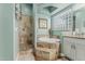 Well-lit bathroom featuring stone-tile shower, garden tub, and light green walls at 3754 E Flintlock Dr, Queen Creek, AZ 85142