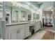 The bathroom features light green walls, dual vanities, and an arched doorframe at 3754 E Flintlock Dr, Queen Creek, AZ 85142