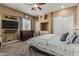 Carpeted bedroom with recessed wall features, a ceiling fan, and large dresser at 3754 E Flintlock Dr, Queen Creek, AZ 85142