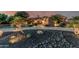 Beautiful desert home featuring manicured landscaping with rock features and an inviting, curved driveway at 3754 E Flintlock Dr, Queen Creek, AZ 85142