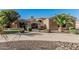 Stunning single-story home with desert landscaping, a circular driveway, and a gated stone archway entrance at 3754 E Flintlock Dr, Queen Creek, AZ 85142