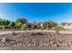 Attractive single-story desert home with circle driveway, palm trees and tasteful xeriscaping at 3754 E Flintlock Dr, Queen Creek, AZ 85142