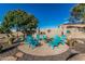 Outdoor firepit with seating surrounded by lush landscaping, ideal for gatherings and relaxation at 3754 E Flintlock Dr, Queen Creek, AZ 85142