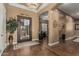 Spacious foyer featuring decorative tile flooring, an elegant chandelier, and an arched doorway to other living areas at 3754 E Flintlock Dr, Queen Creek, AZ 85142