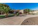 Elegant desert home featuring a circular driveway and a beautifully landscaped front yard at 3754 E Flintlock Dr, Queen Creek, AZ 85142