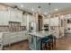 Gourmet kitchen boasts a large island with seating, stainless steel appliances, and stylish finishes at 3754 E Flintlock Dr, Queen Creek, AZ 85142