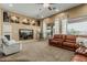 Inviting living room with plush carpeting, a built-in entertainment center, and comfortable seating area at 3754 E Flintlock Dr, Queen Creek, AZ 85142