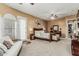 The main bedroom features carpet, light tan walls, a ceiling fan, and a door to the backyard at 3754 E Flintlock Dr, Queen Creek, AZ 85142