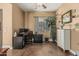 Well-lit home office with ample space, a ceiling fan, a picture window with blinds, and modern electronics at 3754 E Flintlock Dr, Queen Creek, AZ 85142
