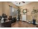 Inviting home office with a ceiling fan, a picture window with blinds, and comfortable desk with rolling chair at 3754 E Flintlock Dr, Queen Creek, AZ 85142
