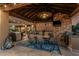 Covered outdoor kitchen and dining area with a built-in grill, TV, and comfortable seating for entertaining guests at 3754 E Flintlock Dr, Queen Creek, AZ 85142