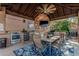 Covered patio featuring a complete outdoor kitchen with stainless steel appliances, a built-in grill, and dining space at 3754 E Flintlock Dr, Queen Creek, AZ 85142