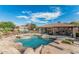Beautiful backyard oasis featuring a pool, spa, outdoor kitchen, and a spacious patio for relaxing and entertaining at 3754 E Flintlock Dr, Queen Creek, AZ 85142